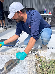Worker preparing the edge of a resin surfacing installation using a trowel