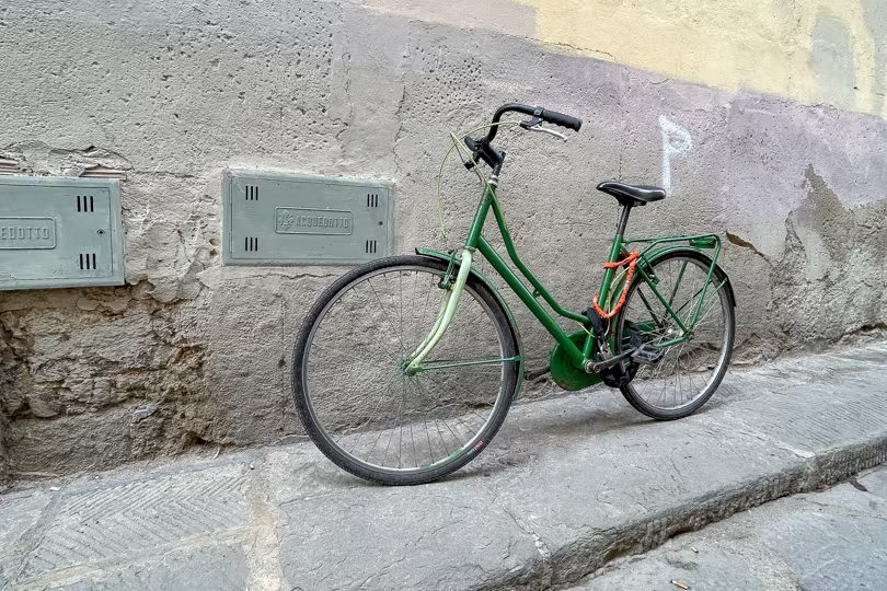 A bicycle against the wall in Florence, Italy, showing a typical Italian scene.