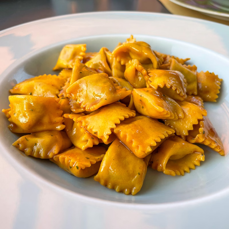 Bowl of agnolotti di plin pasta from La Piola in Alba, Italy.