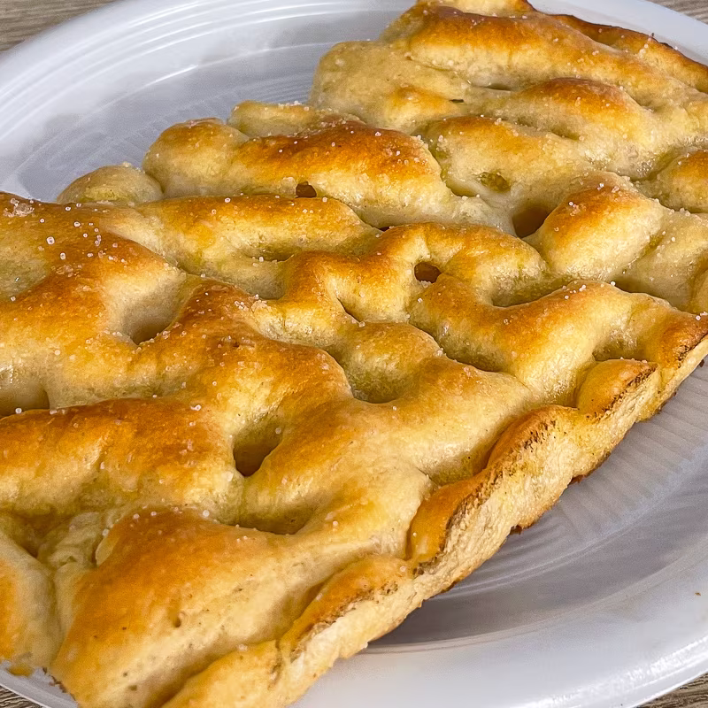 Plain focaccia bread on a plate.