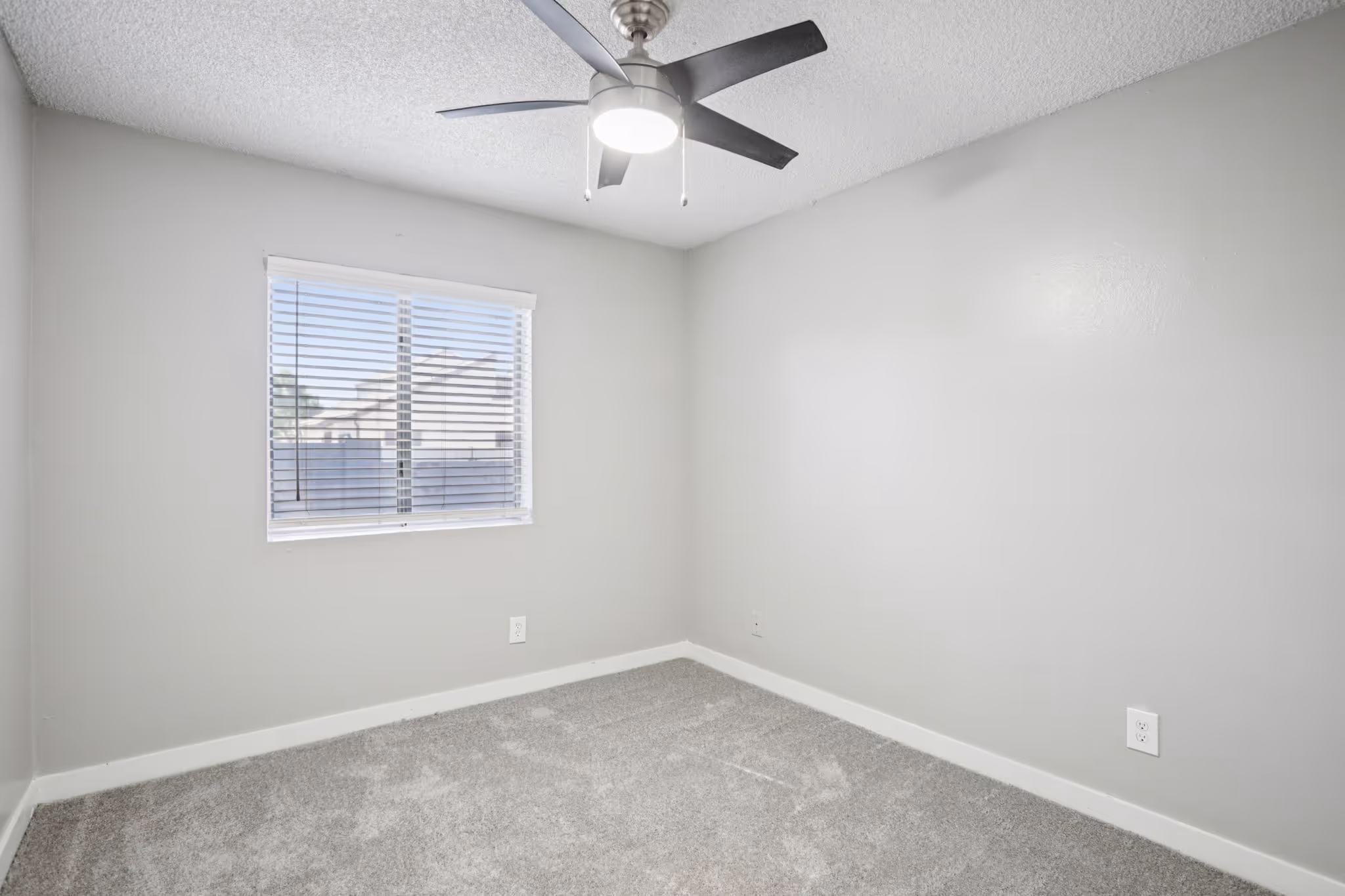 unfurnished bedroom with window and ceiling fan