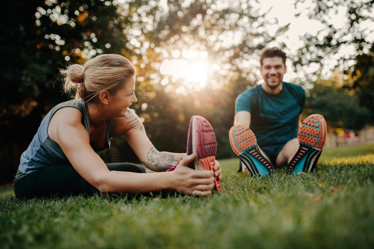 couple stretching on the grass