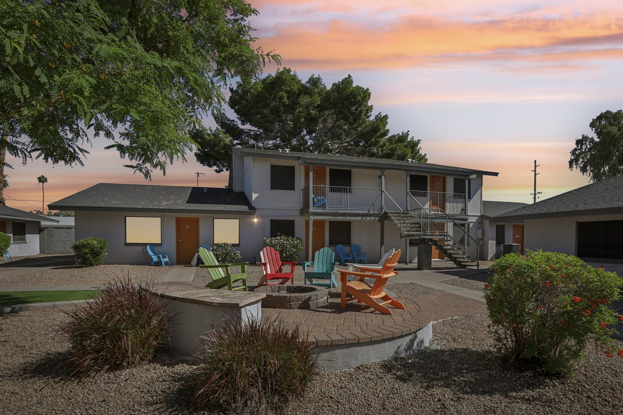 fire pit with chairs at sunset