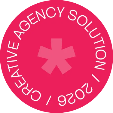 Pink circular badge with a star shape in the center and the text ‘CREATIVE AGENCY SOLUTION / 2026’ curved around the edge.