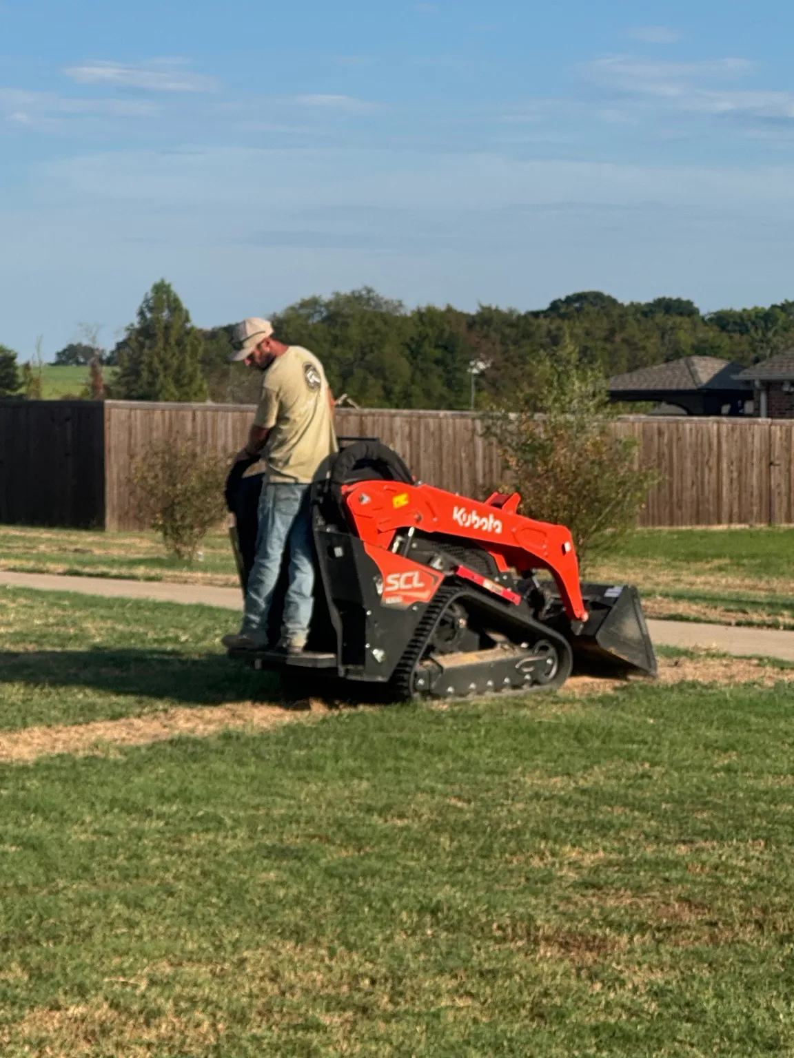 Our team operating compact equipment during an irrigation installation