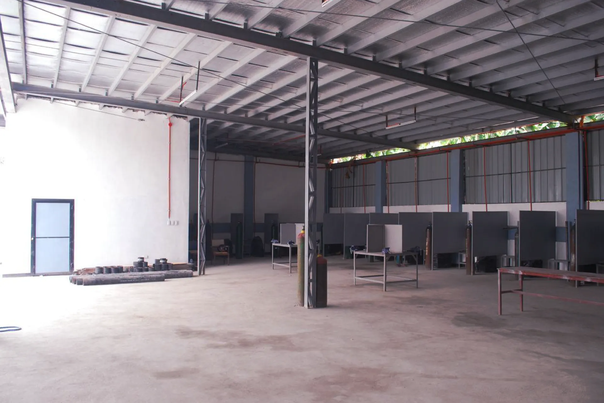 Spacious interior of an industrial workshop with a steel frame structure and prepared work areas