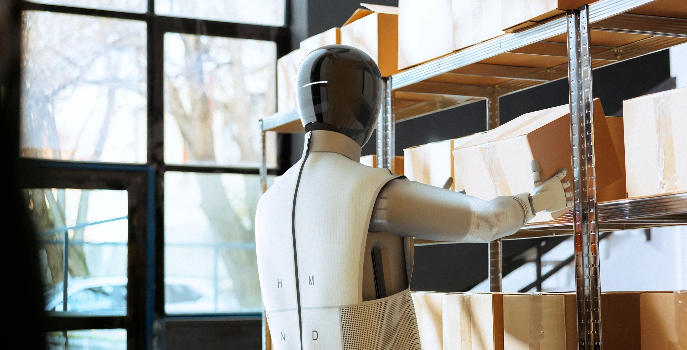 HMND 01 humanoid robot handling boxes in a warehouse environment