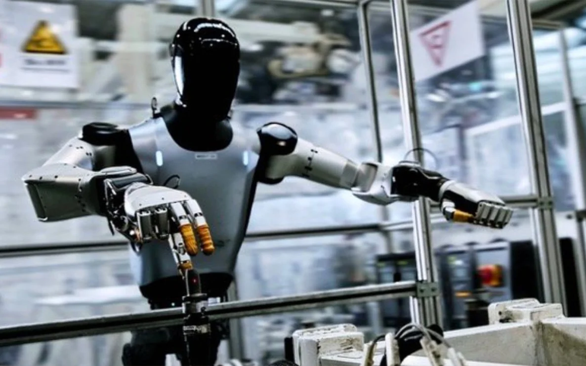 Xiaomi humanoid robot working at a self-tapping nut station in an automotive factory