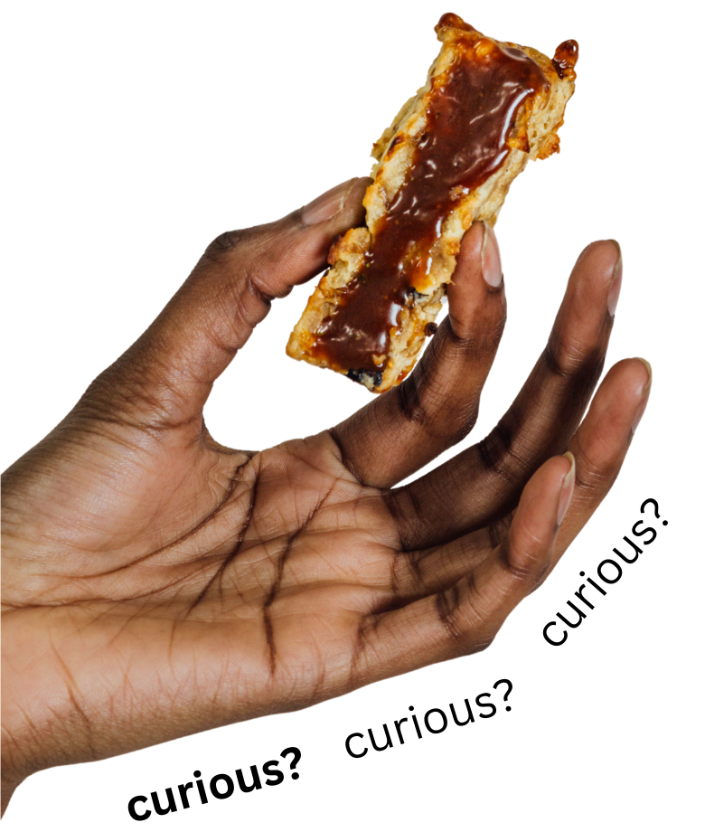 A brown hand delicately holds a pastry between thumb and forefinger in an offer. The pastry is flaky, golden brown, and has a shiny red center.