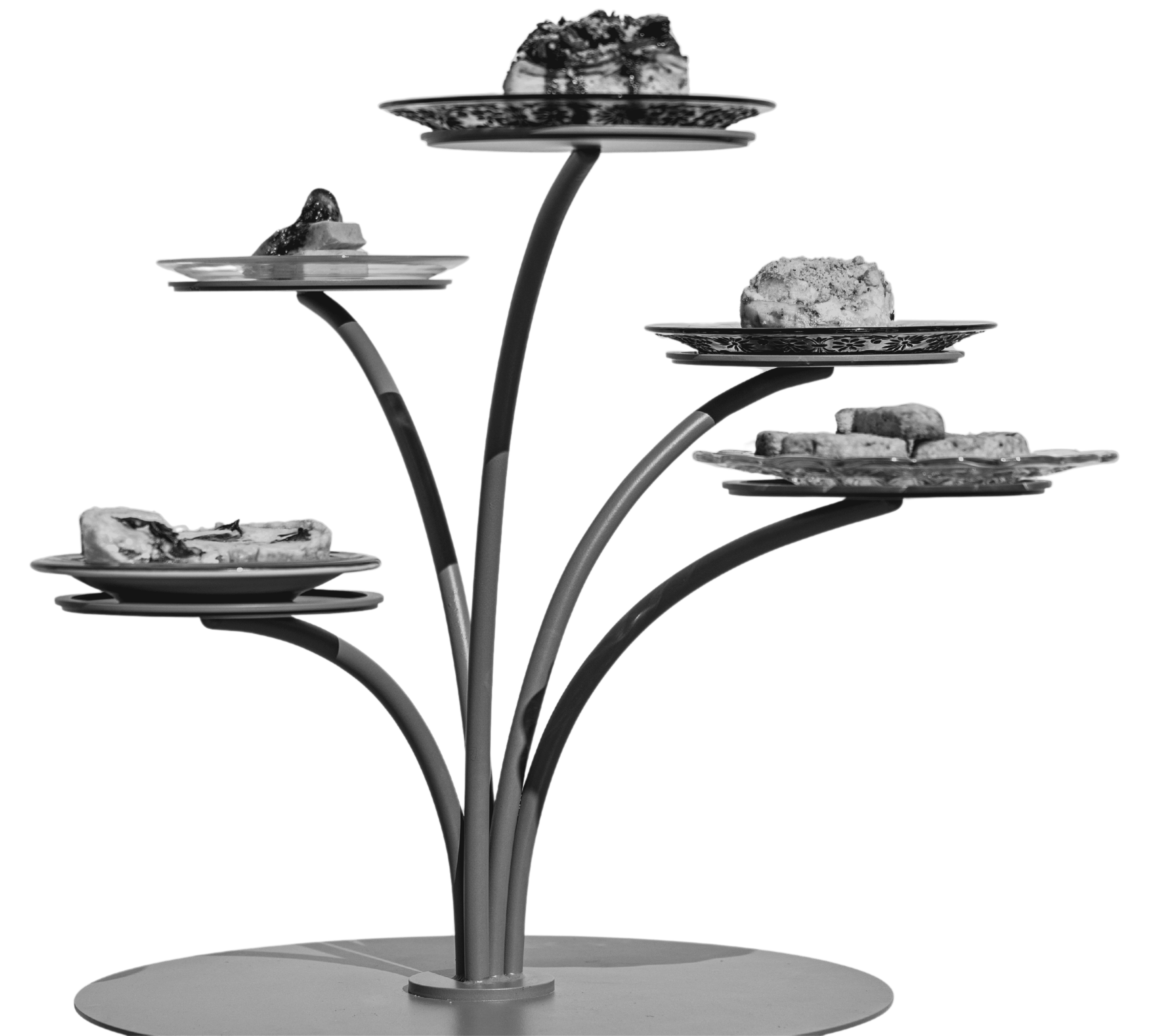 A tree-like platter of food, with five tiers. Each tier holds a small plate with a pastry on it.