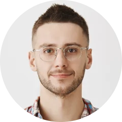 A man wearing glasses and a plaid shirt.