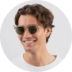 A man wearing sunglasses and a white t - shirt.