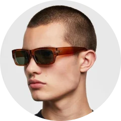 A man with a shaved head wearing sunglasses.