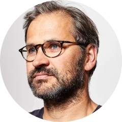 A close up of a person wearing glasses.