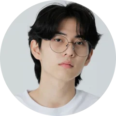 A man with glasses looking at the camera.