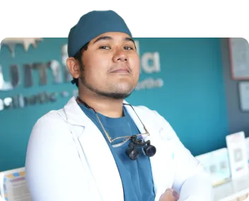 Portrait of doctor Mark wearing a traditional Filipino barong tagalog with a warm orange background.