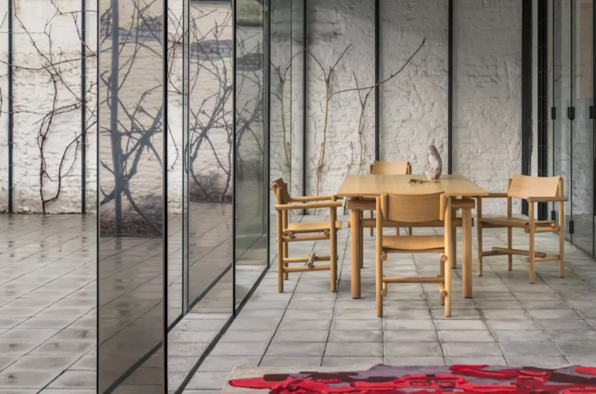Knoll dining table and chairs in a glass-walled room