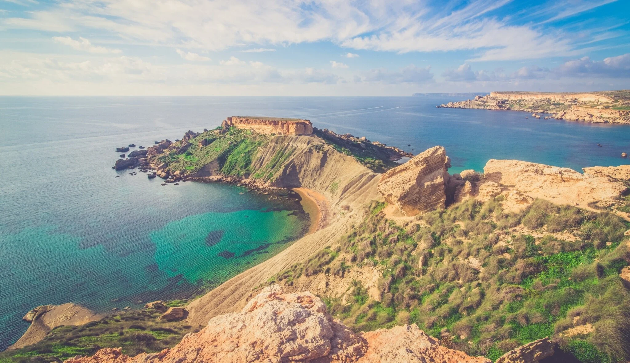  Scenic view of the ocean and mountains from a hilltop, showcasing the natural beauty of the landscape.