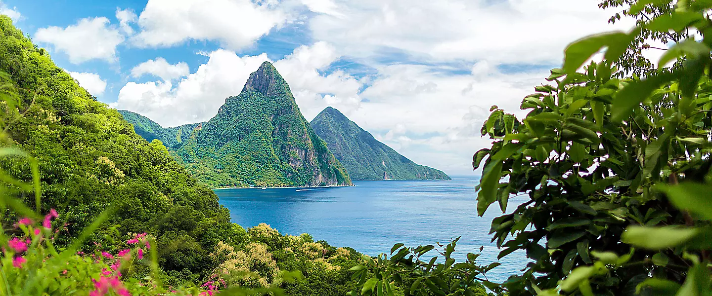  Scenic view of the ocean and mountains from a hilltop, showcasing the natural beauty of the landscape.