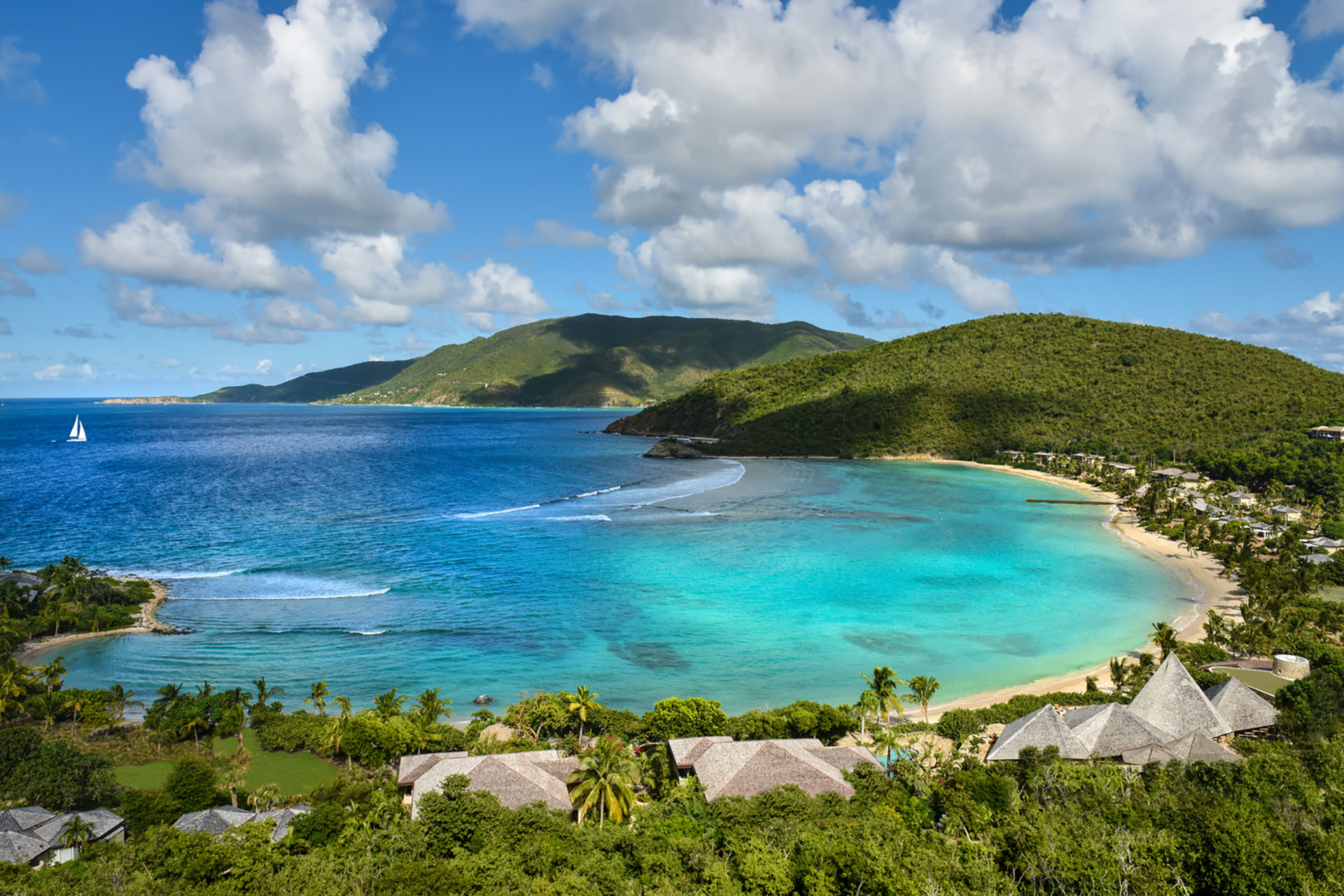  Scenic view of the ocean and mountains from a hilltop, showcasing the natural beauty of the landscape.