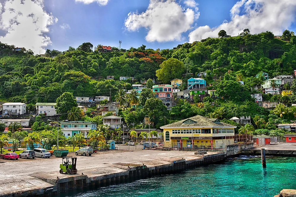  Scenic view of the ocean and mountains from a hilltop, showcasing the natural beauty of the landscape.