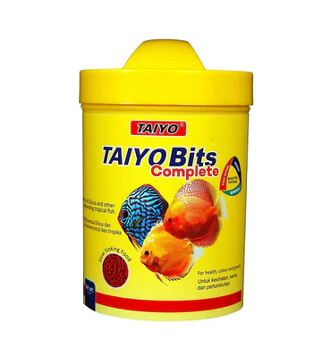 Yellow container of TAIYO Bits Complete fish food with images of tropical fish on the label.