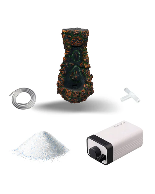Aquarium decoration kit with a faux coral cave, air tubing, a T-shaped connector, white granular air stone, and a white air pump with a black control knob.