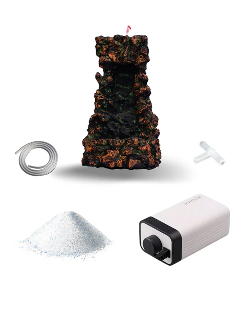 Aquarium fountain decoration set including a rocky waterfall ornament, air tubing, T-shaped connector, granular filter media, and a rectangular air pump with control knob.