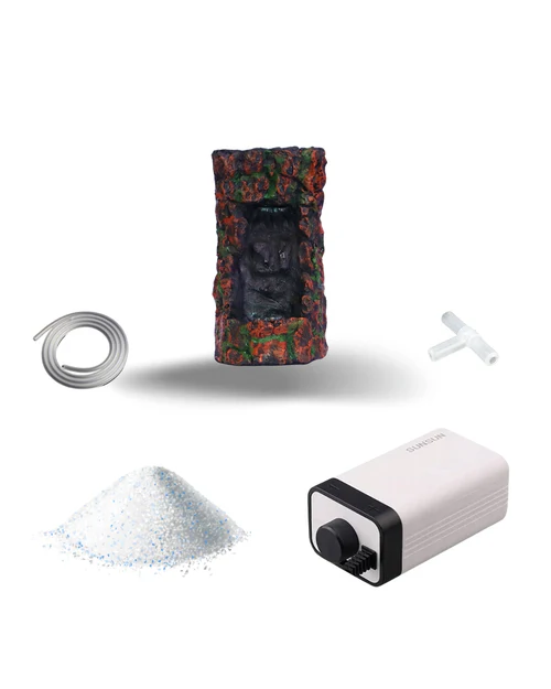 Aquarium air pump kit including air pump, decorative stone cave, air tubing, T-shaped connector, and a pile of white aquarium stones.