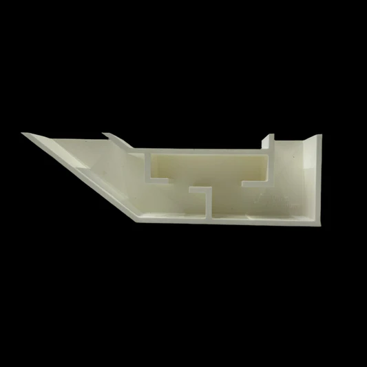 White plastic architectural model of a building floor plan against a black background.