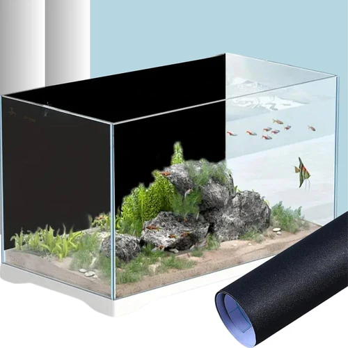 Rectangular aquarium with rocks, green plants, and small colorful fish swimming inside, shown with a black background film partially peeled.