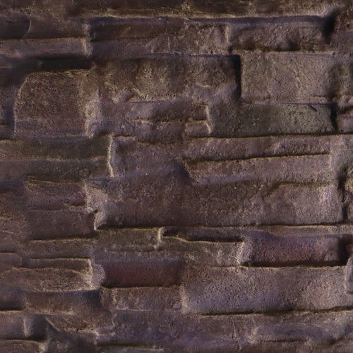 Close-up of dark brown textured stone wall with layered rectangular blocks.