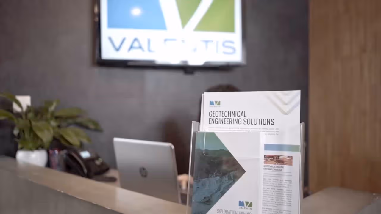 Brochure titled 'Geotechnical Engineering Solutions' displayed on a desk in a modern office reception area.