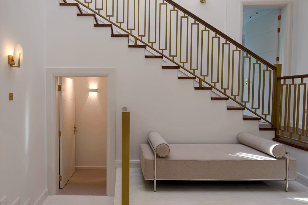Hallway staircase with gold railing in Al Barari luxury villa renovation Dubai