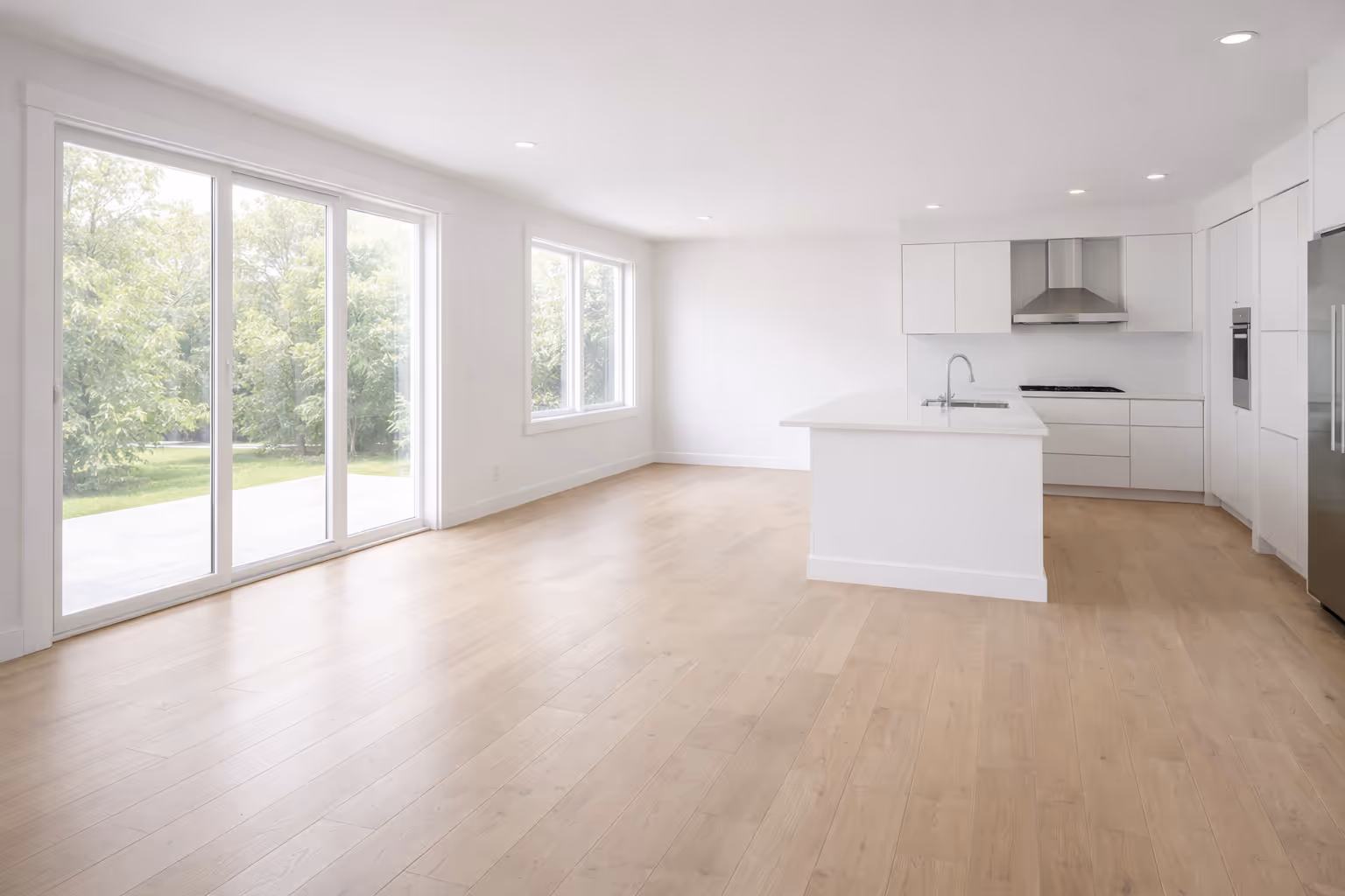 Newly finished residential interior after post-construction cleaning, with clean floors and bright natural light