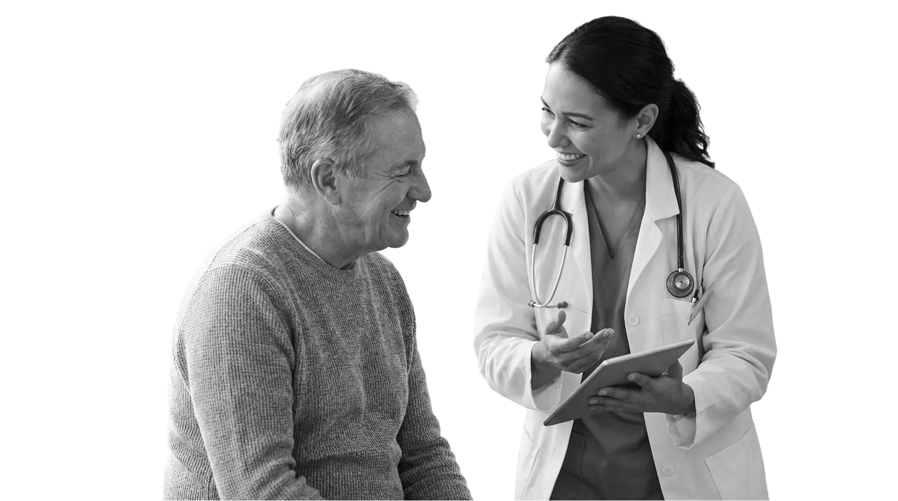 Smiling female doctor with a stethoscope talking to an elderly male patient holding a tablet.