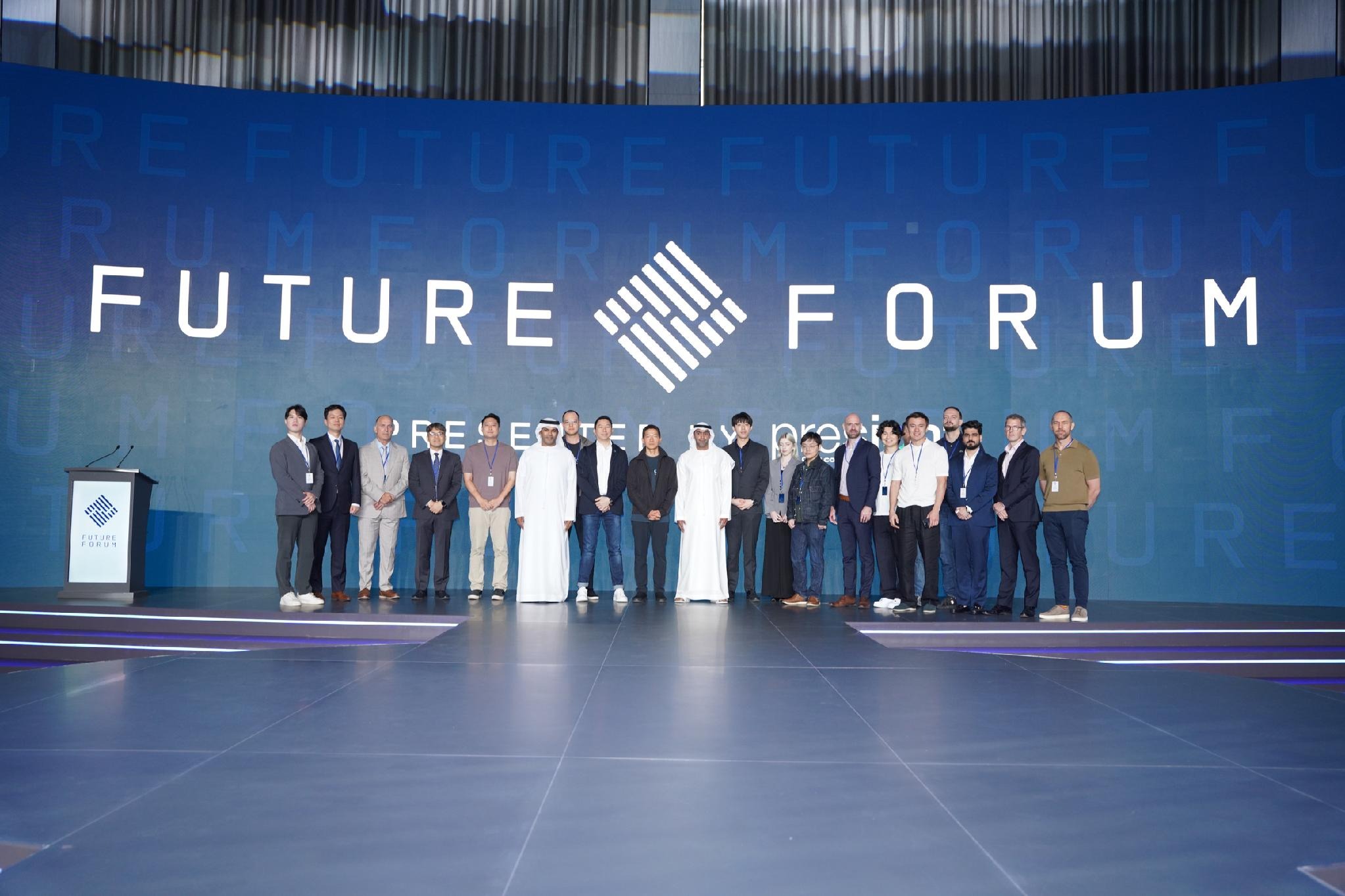 Participants gathered for a group photograph on stage at Future Forum.