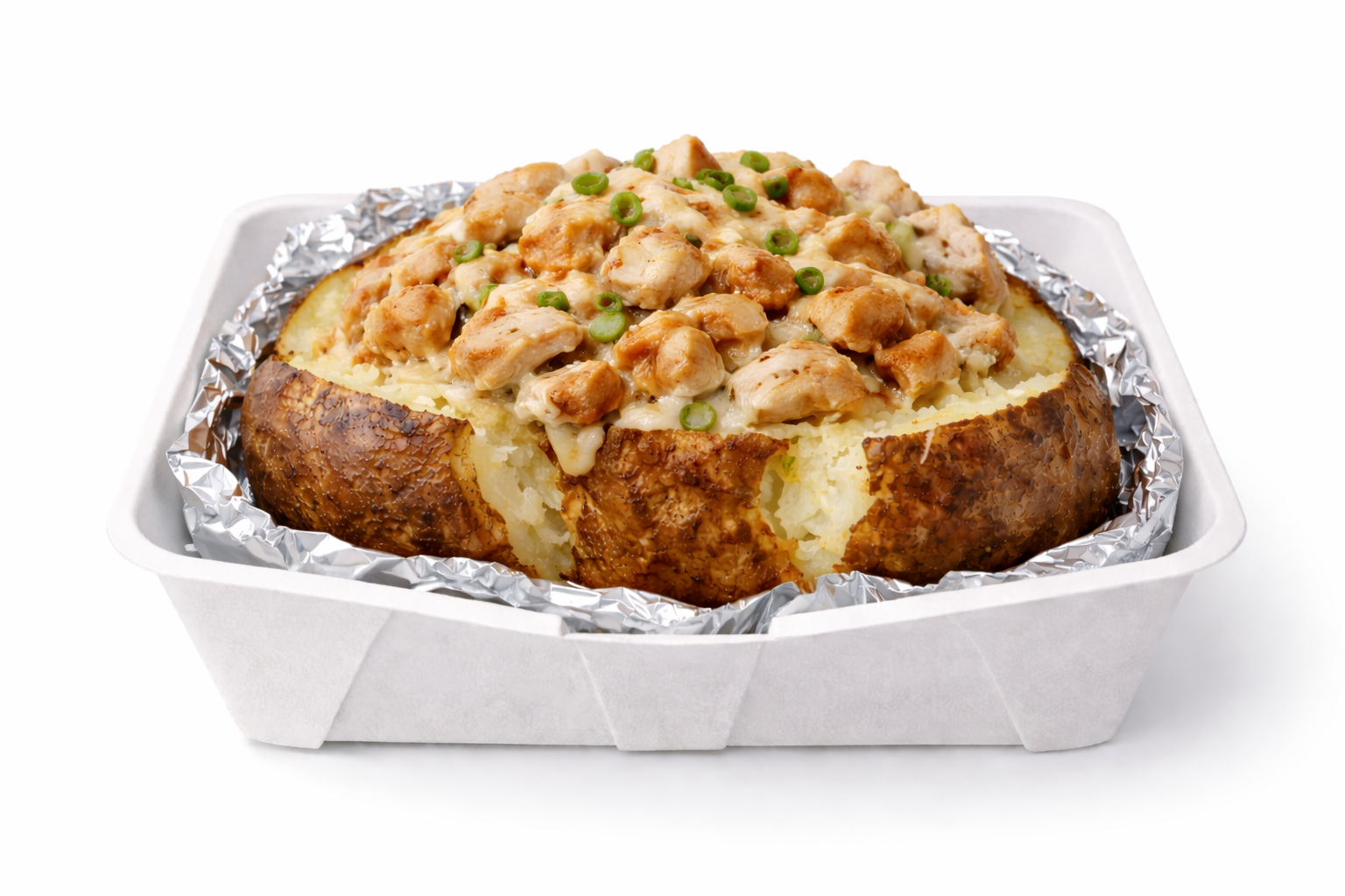 Baked jacket potato topped with chunks of cooked chicken, melted cheese, and sliced green onions in a foil-lined container.