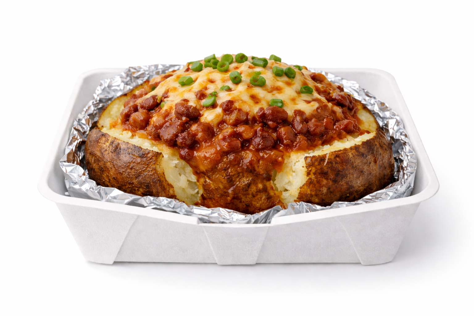 Baked potato topped with chili beans, melted cheese, and chopped green onions in a foil-lined container.