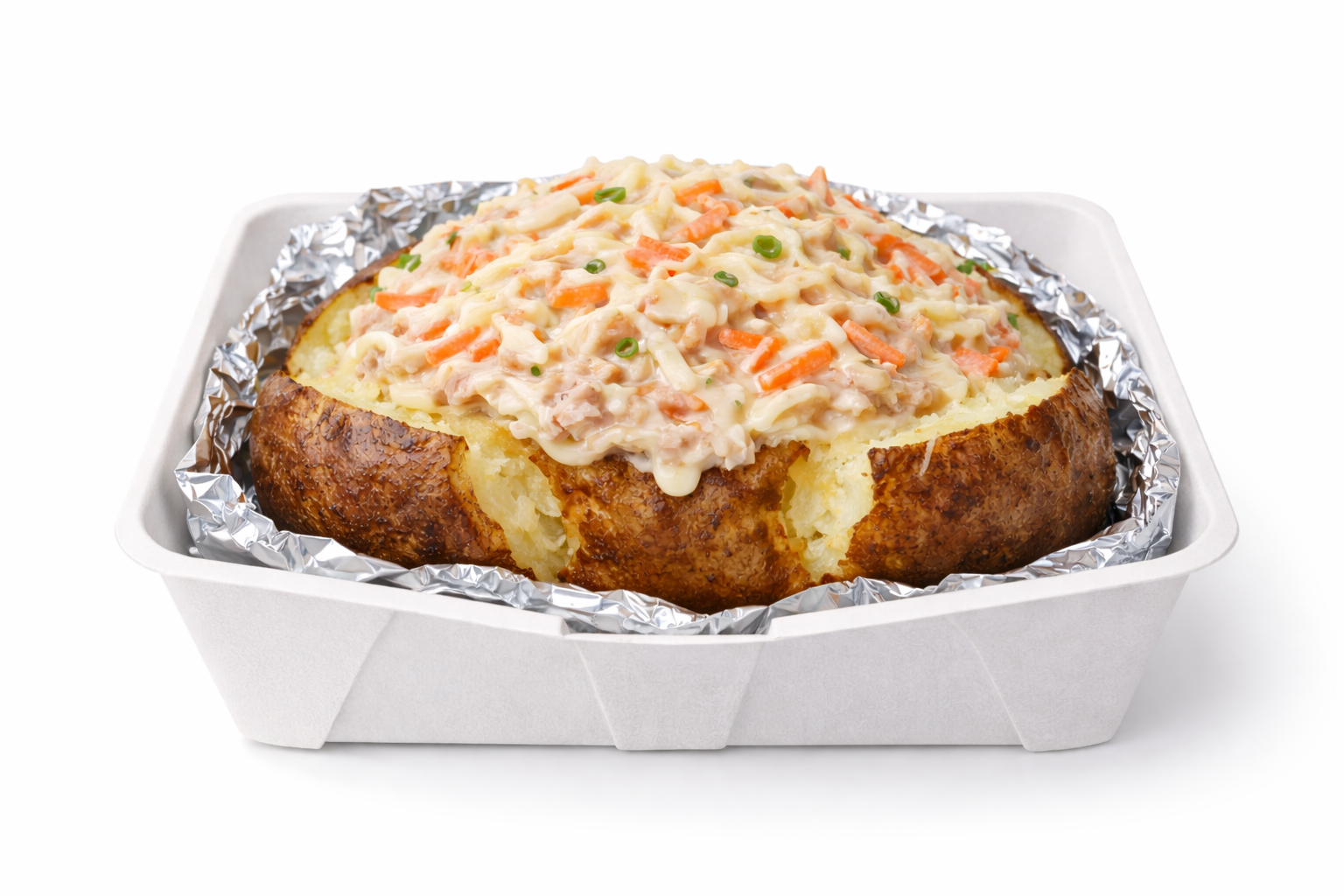 Baked potato topped with creamy tuna salad mixed with shredded carrots and spring onions, served in a foil-lined paper tray.