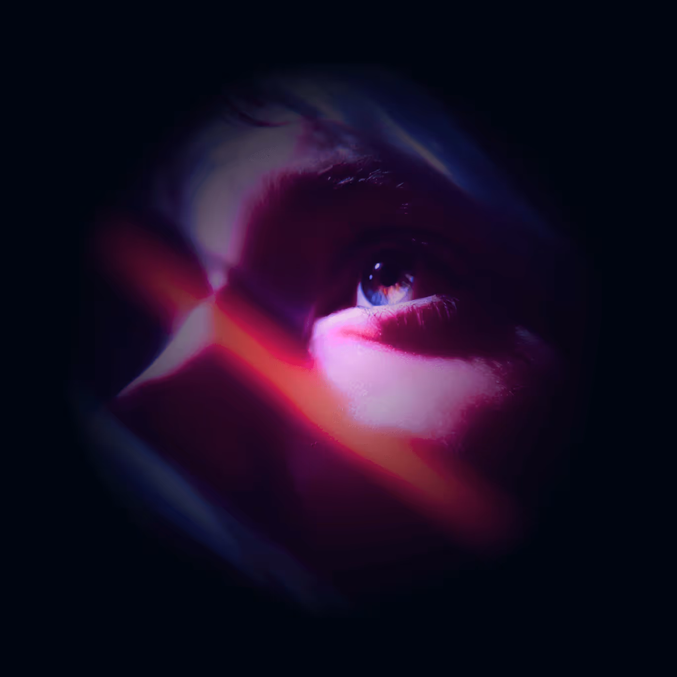 Close-up of a person’s eye illuminated by pink and red light beams in a dark setting.