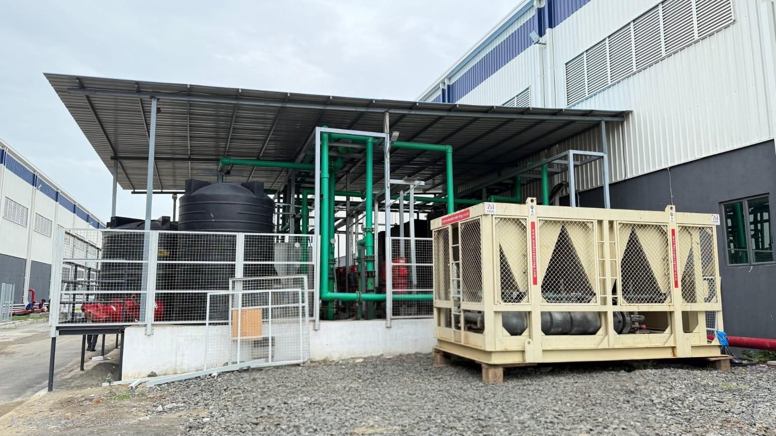Industrial Modern brand air-cooled chiller unit with visible compressors and cooling fans on top.