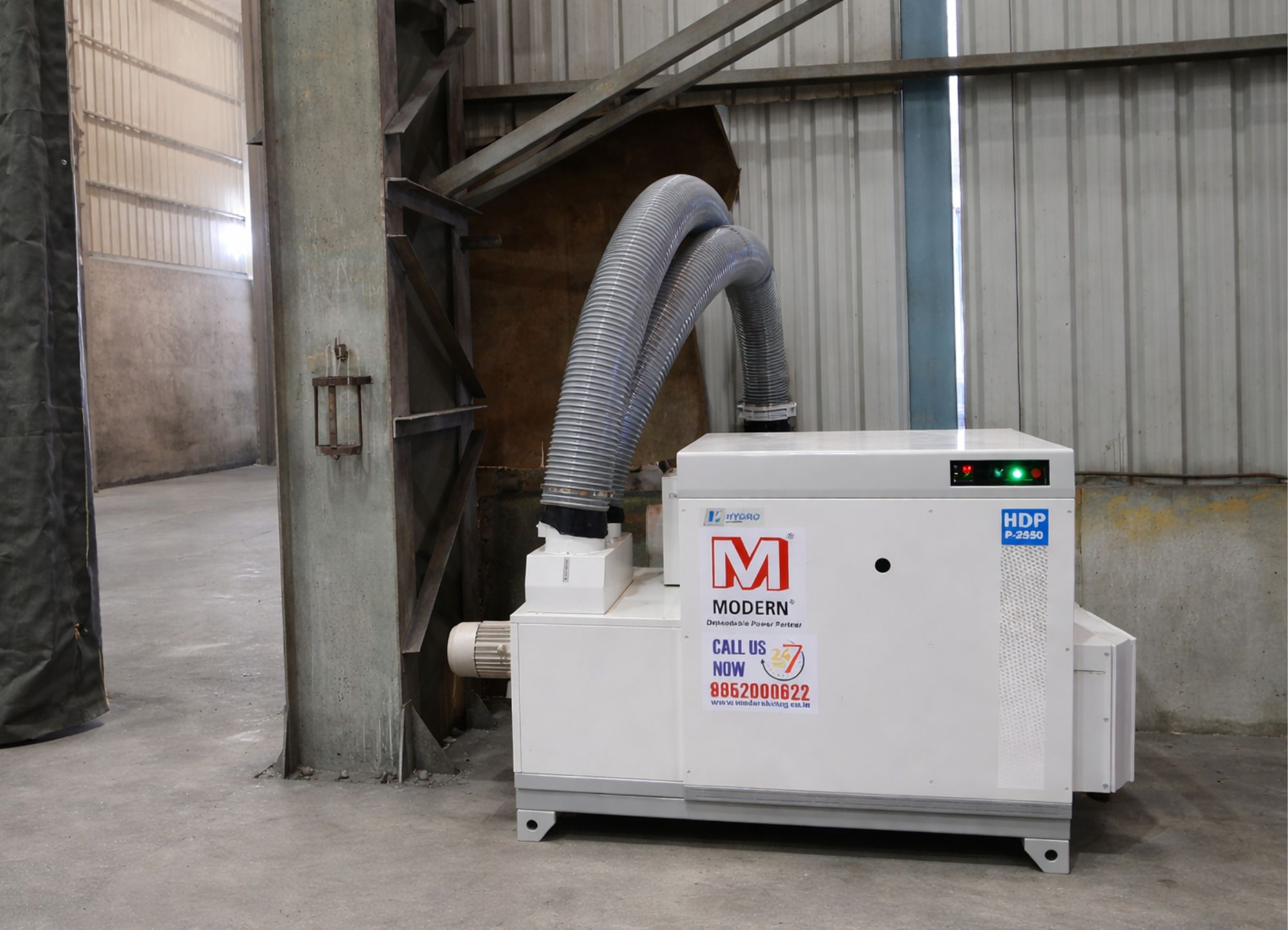White industrial machine labeled Modern with two large flexible exhaust pipes in a warehouse setting.