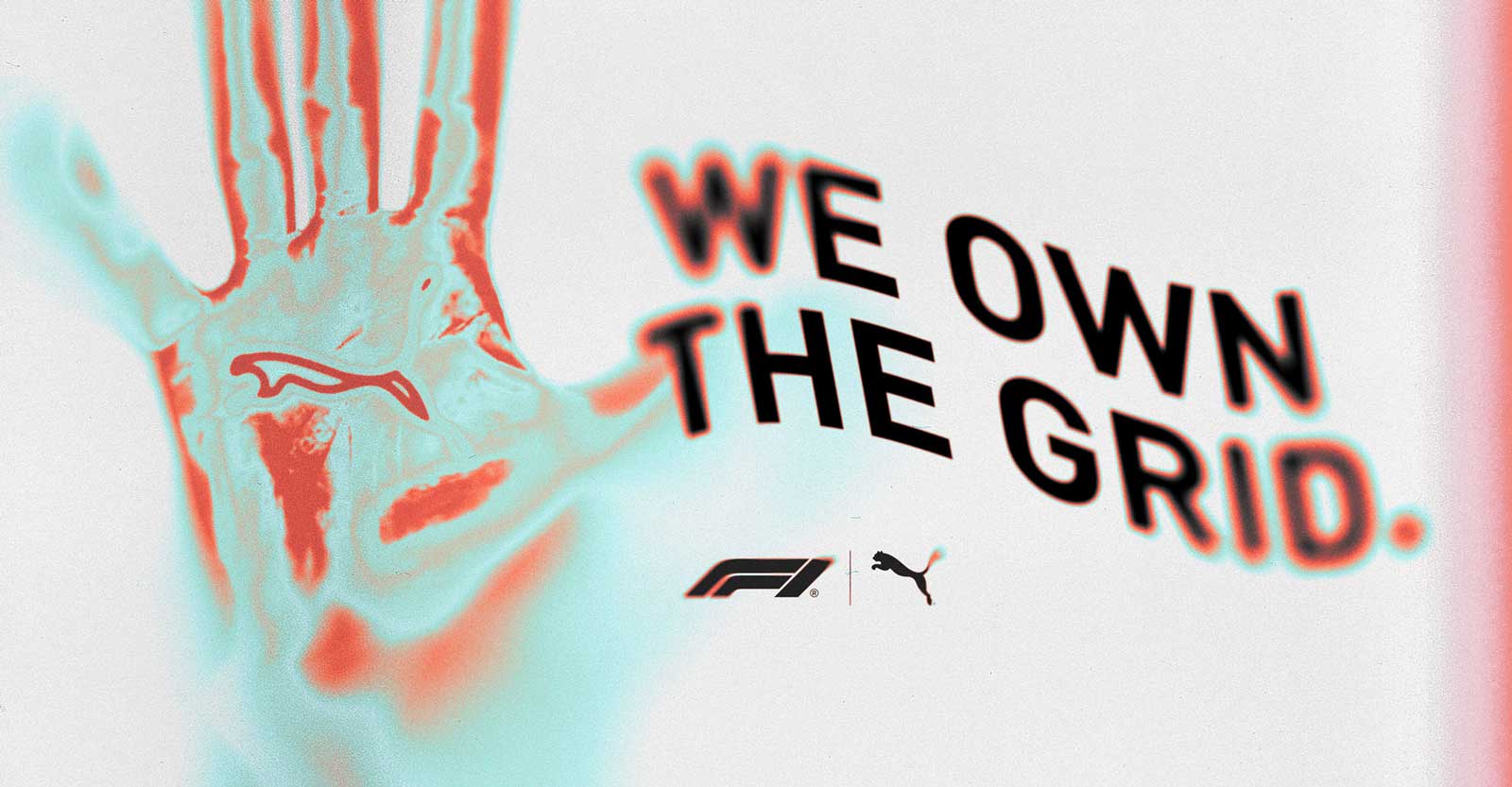 An artistic image of a skeleton hand with red and blue overlay, next to bold text reading 'WE OWN THE GRID.' with F1 and Puma logos beneath.