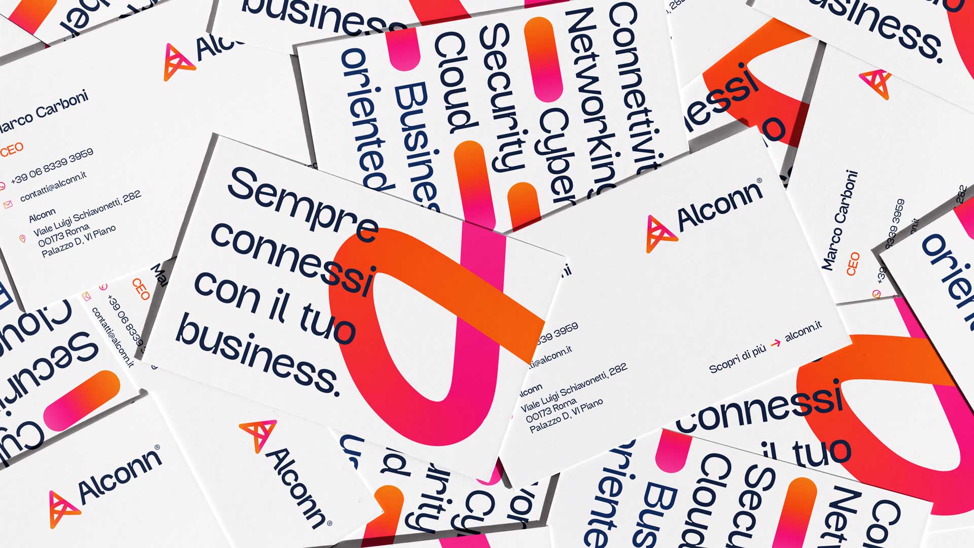 Scattered Alconn business cards featuring the logo, contact details for Marco Carboni CEO, and phrases like 'Sempre connessi con il tuo business.' and technology keywords.