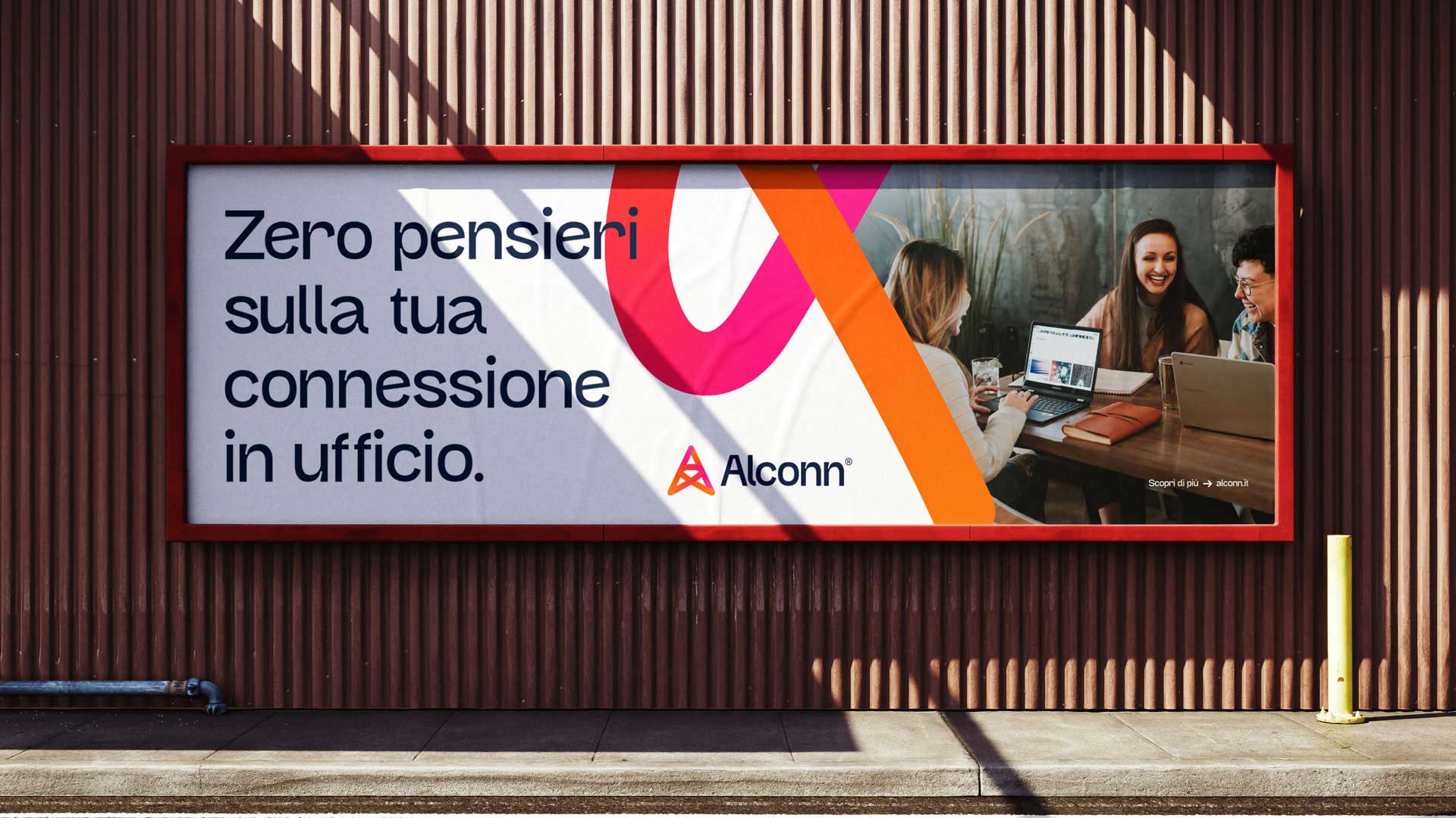Outdoor billboard with Italian text about zero worries regarding office connection, featuring three people working and laughing with laptops.