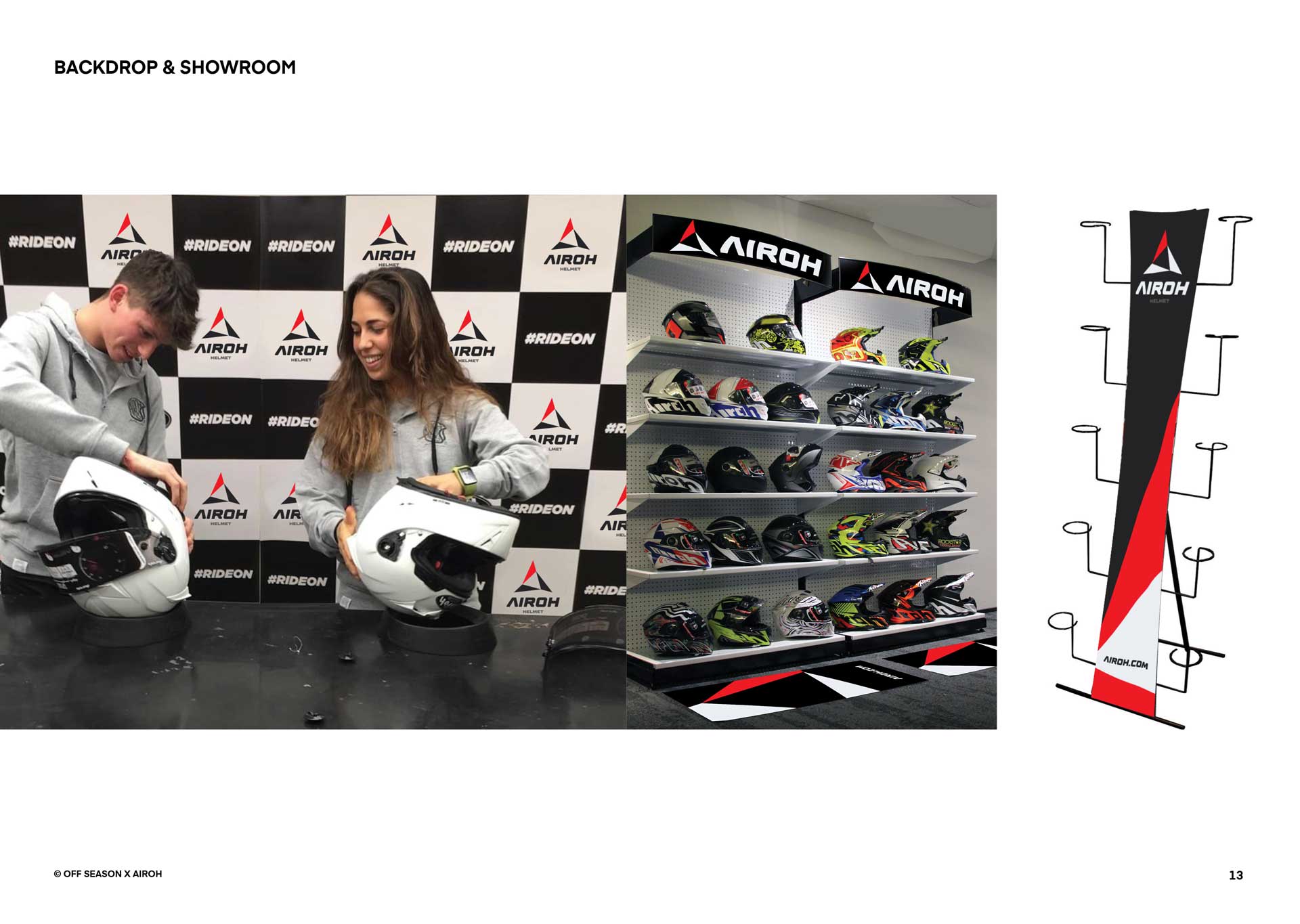 Two people examining white Airoh helmets in front of a black and white branded backdrop, with shelves of colorful Airoh helmets and a helmet display stand graphic.