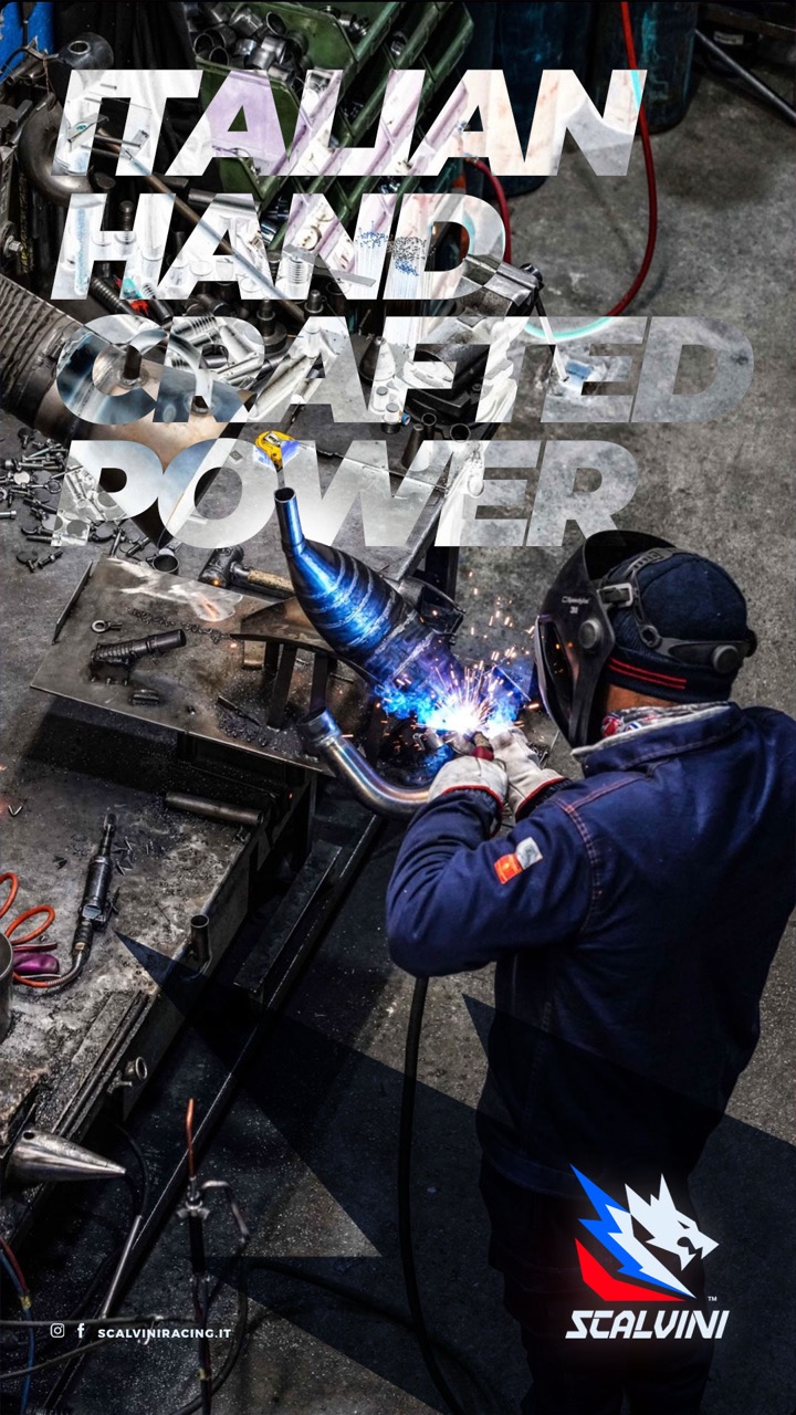 Worker wearing protective gear welding a metal exhaust pipe in a workshop with the text 'Italian Hand Crafted Power' overlayed.