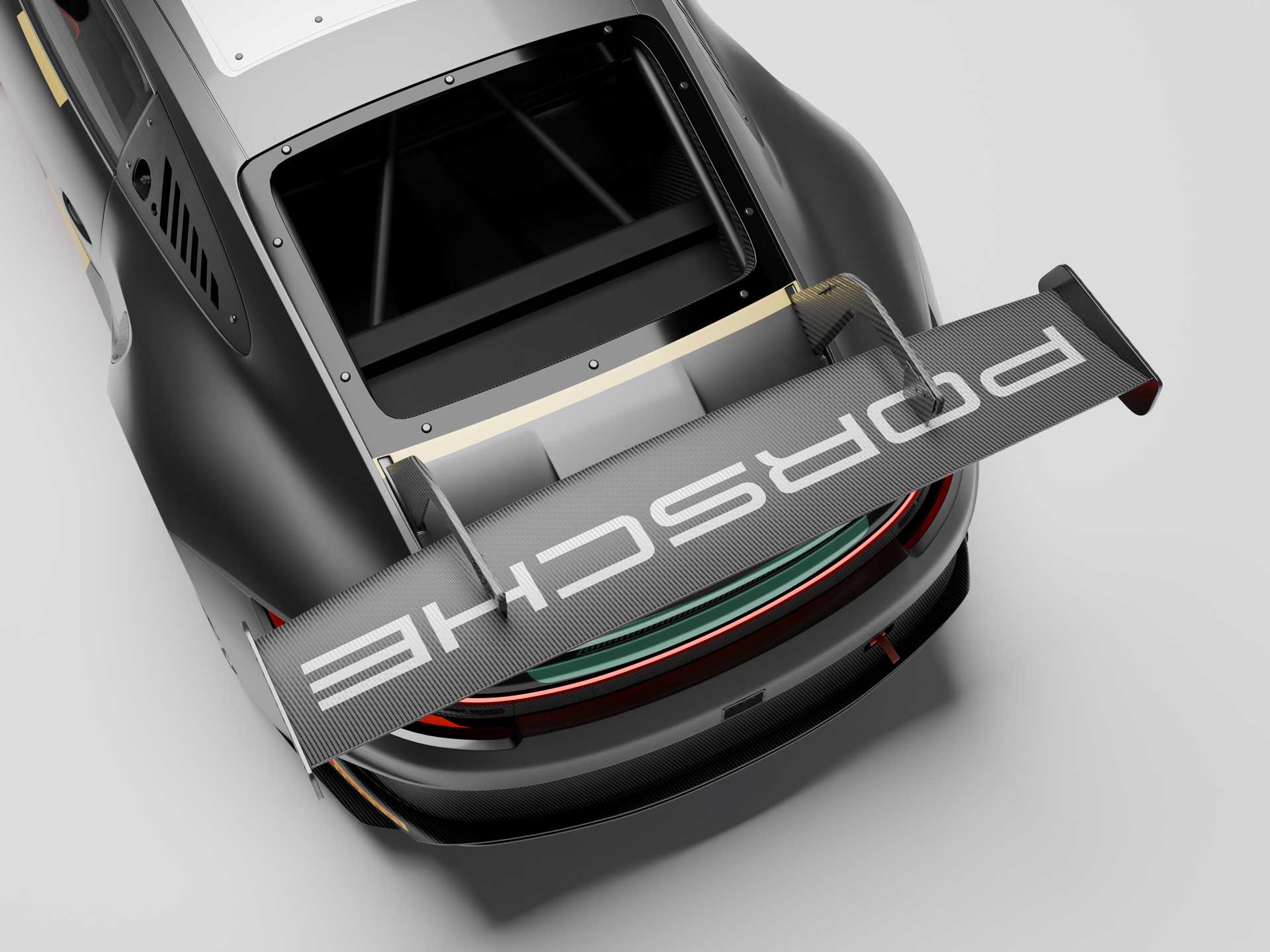 Top-down view of a sleek black Porsche race car highlighting a large rear spoiler with Porsche branding.