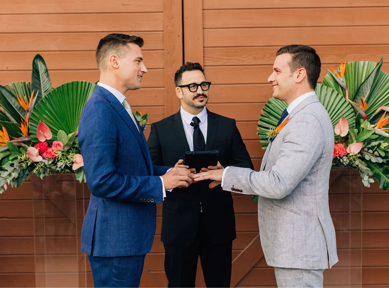 A couple standing in front of the officiant